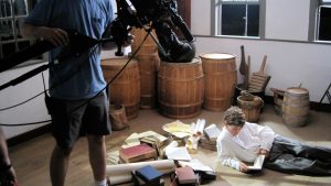 behind the scenes of filming young boy reading books at adams